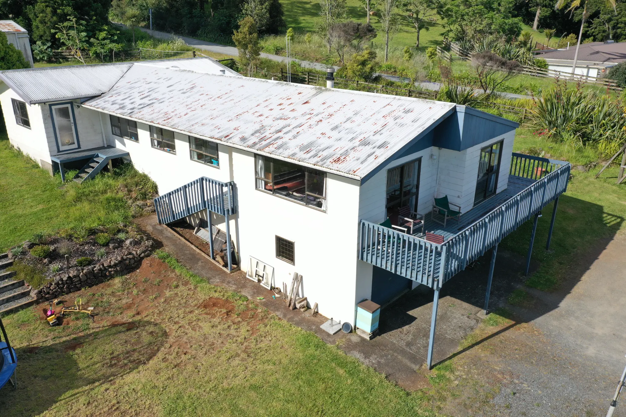 Aerial view of property before deck extension showing old blue deck