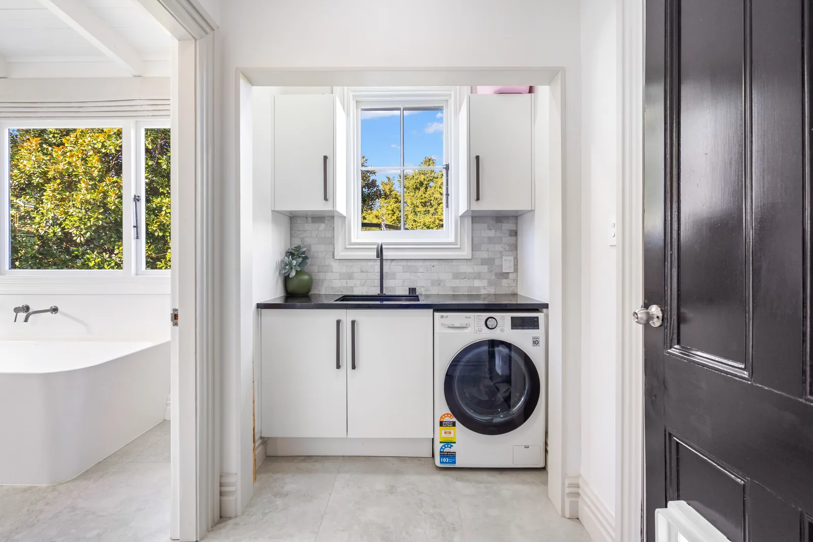 Relocated finished laundry with sink, storage and washing machine