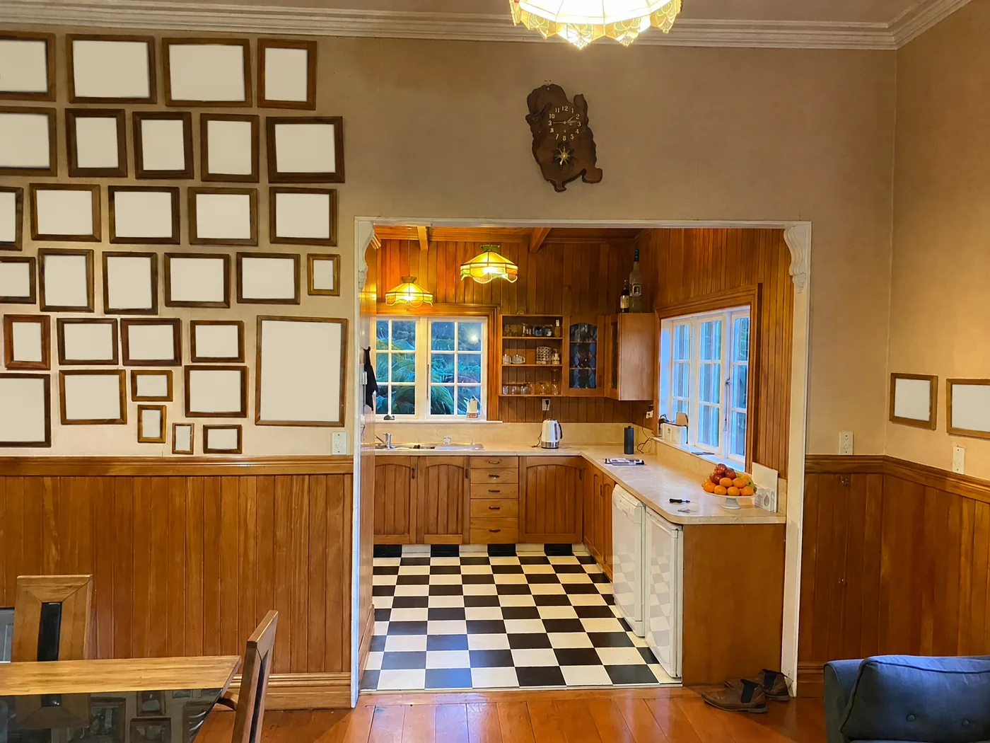 Kitchen and dining room before the villa renovation, with family wall photographs blanked