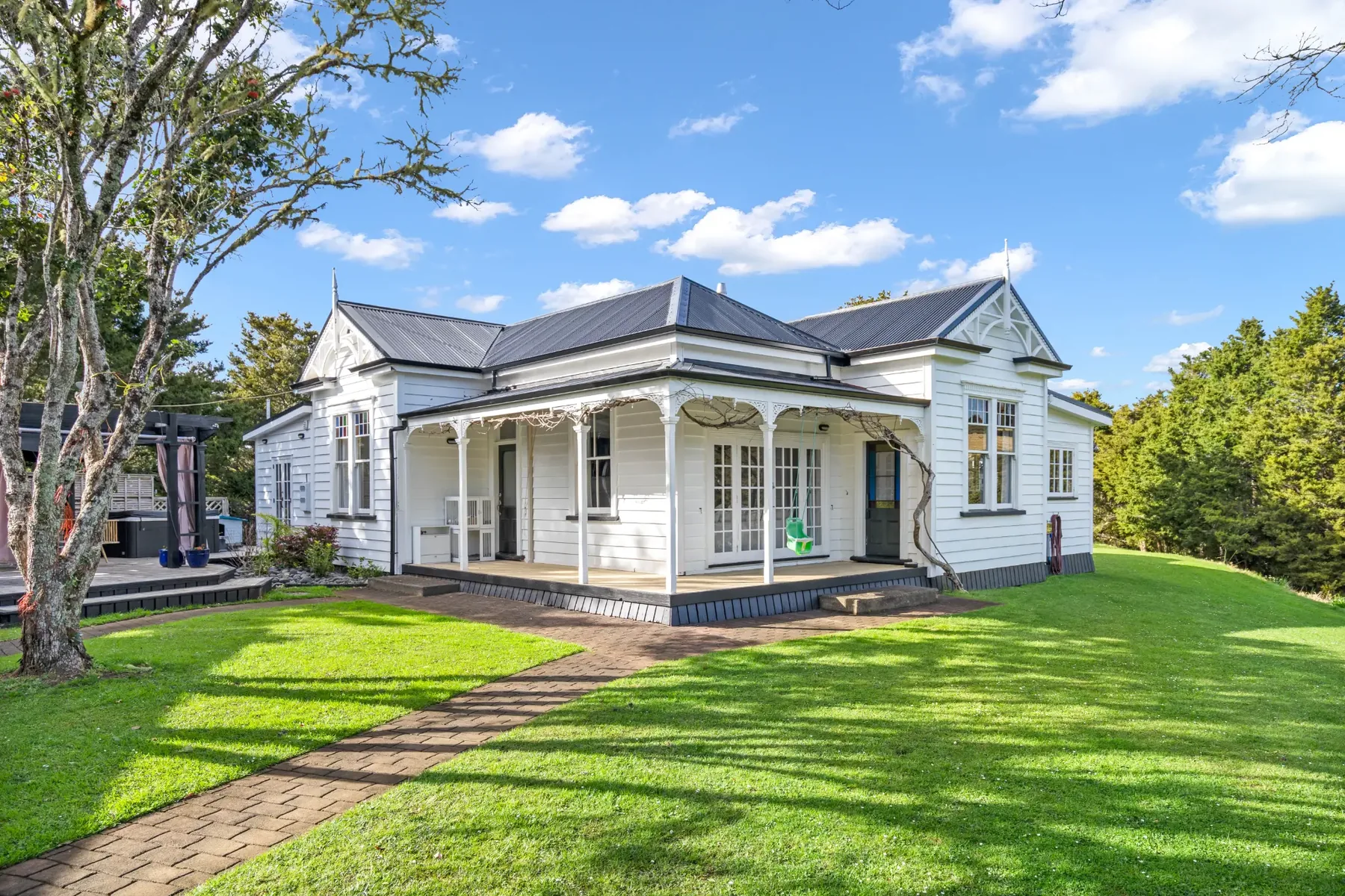 Finished white character villa with a dark new roof and a covered verandah near Ngunguru